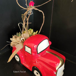 Red truck planter with succulents and a twig topper