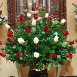 Large arrangement of red and white roses in a vase