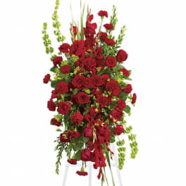 Tall red floral spray on a white stand