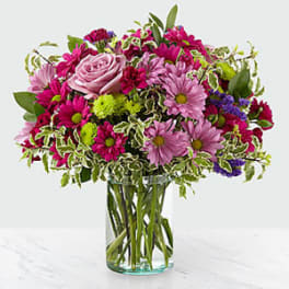 Pink and purple mixed bouquet in a clear glass vase