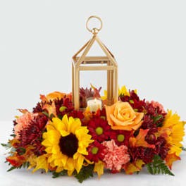 Autumn floral arrangement with a lantern and candle