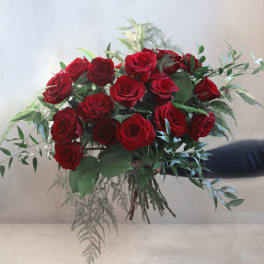 Bouquet of red roses with mixed greenery