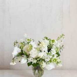 White floral arrangement in a clear glass vase