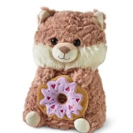 Plush teddy bear holding a donut-shaped toy