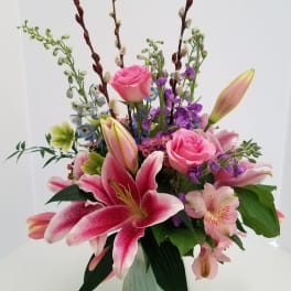 Pink lilies and roses in a green vase