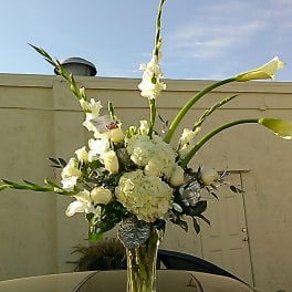 Calla Lilies, orchids, gladiolus, hydrangea, roses, alstromeria