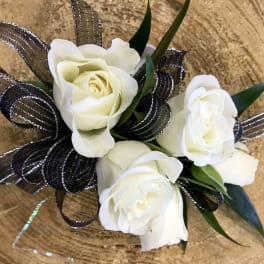 Small bouquet of white roses with black ribbon loops