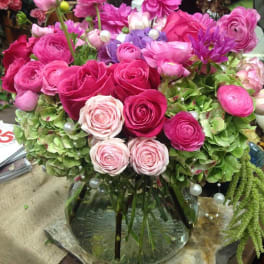 Pink and purple flower arrangement in a glass vase
