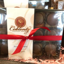 Boxed chocolates tied with a red ribbon
