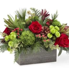 Red roses and green flowers in a rectangular gray container
