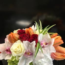 Bouquet of red and cream roses with white orchids and orange tulips