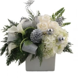 White roses and hydrangeas in a square vase with silver accents