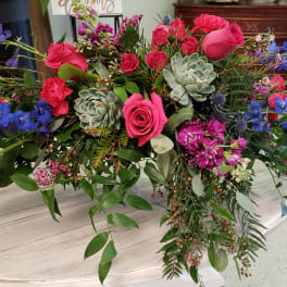 Large mixed bouquet with pink roses, blue flowers, and succulents