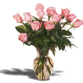 Pink roses arranged in a clear glass vase
