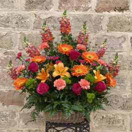 Colorful mixed flower arrangement in a wicker basket