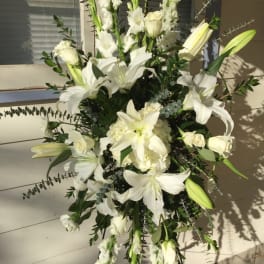 Tall white floral spray with lilies and roses