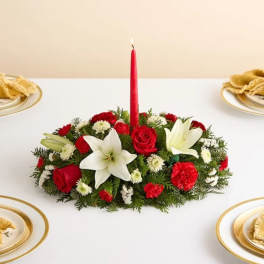 Red and white floral centerpiece with a tall red candle
