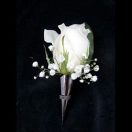 White rose boutonniere with baby's breath on a dark background