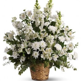 White mixed flowers arranged in a woven basket