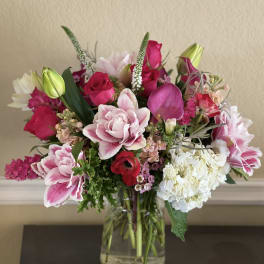 Pink and white mixed bouquet in a clear glass vase