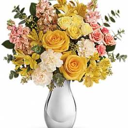 Yellow and pink mixed flower bouquet in a clear glass vase