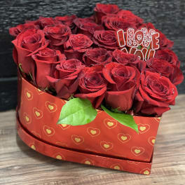 Heart-shaped box of red roses with an "I LOVE YOU" topper