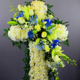 Large white and yellow floral standing spray with blue accents
