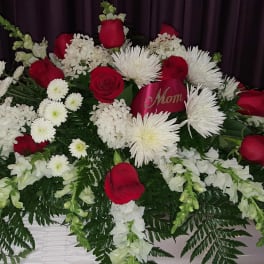 Red roses and white chrysanthemums arranged on a casket