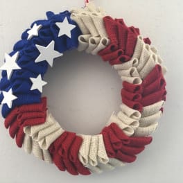 Patriotic wreath with red, white, and blue fabric folds and white stars