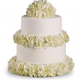 Three-tier white cake decorated with white flowers
