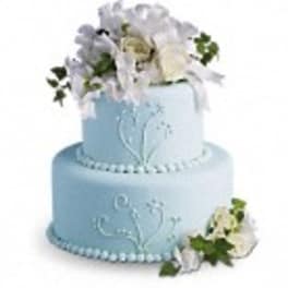 Two-tier light blue cake with white floral decorations