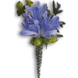 Blue flower boutonniere with green berries and wrapped stem