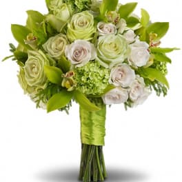 Bouquet of pale green and white roses with orchids and green accents