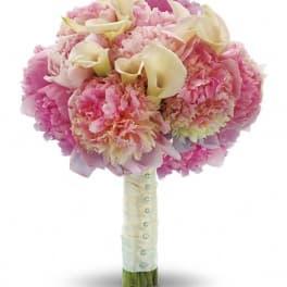 Pink bouquet with cream calla lilies and carnations wrapped in satin ribbon