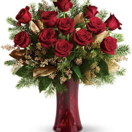 Red roses arranged in a burgundy vase with gold accents