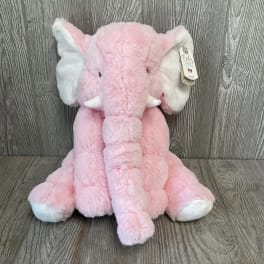 Pink plush elephant stuffed animal with white ears and tusks