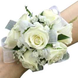 White rose wrist corsage with sheer ribbon and small white filler flowers