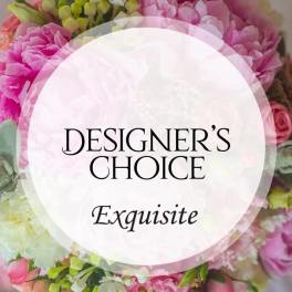 Pink and white floral arrangement with a designer's choice label