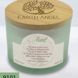 Green candle in a glass jar with a wooden lid