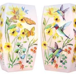 Pair of pink glass candle holders with yellow flowers, butterflies, and hummingbirds