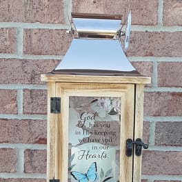 Wooden lantern with a sympathy message and butterfly design