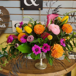Colorful mixed flower arrangement in a silver vase