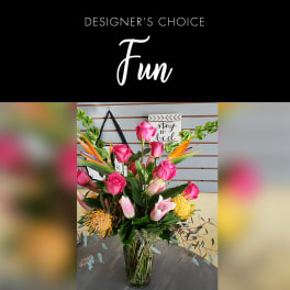 Pink rose and tropical flower arrangement in a clear glass vase