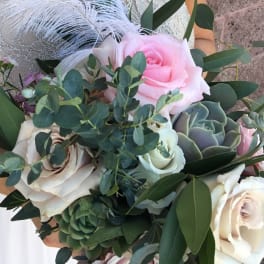 Handheld bouquet of pink and white roses with succulents and greenery