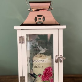 White memorial lantern with a candle and floral print