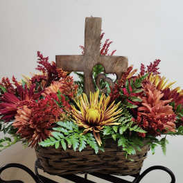 Basket arrangement with chrysanthemums and a wooden cross centerpiece