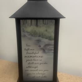 Black memorial lantern with a printed sympathy message