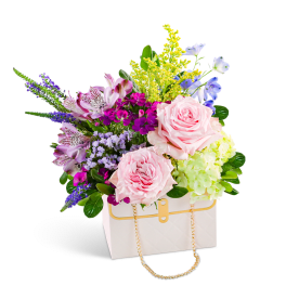 Pink roses and mixed flowers in a white handbag-shaped box