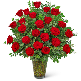 Red roses arranged in a clear glass vase
