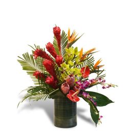 Tall tropical flower arrangement with bold red, orange, green, and purple blooms in a green vase